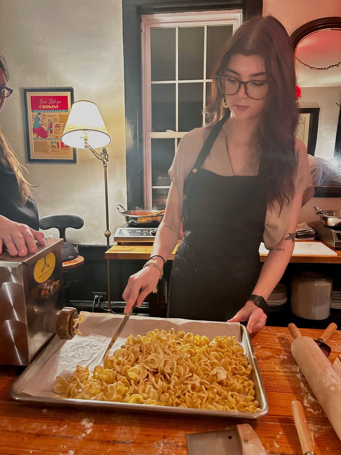 The Reporter’s Elizabeth DeFalco cuts rigatoni as it’s pressed from an extruder.
