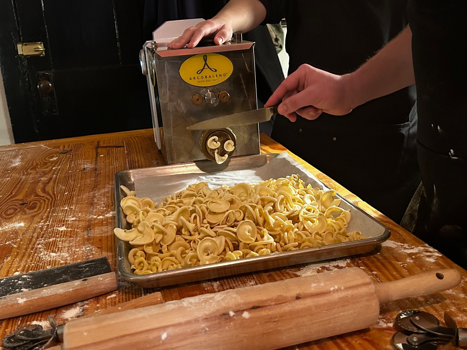 Semolina-based dough is pressed through a pasta extruder to mold the signature spiral shape of rigatoni.